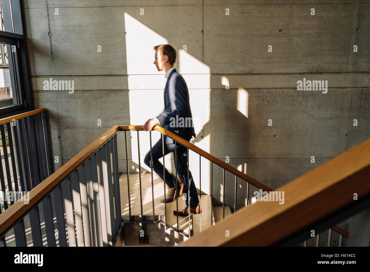 Businessman walking up stairs Stock Photo - Alamy
