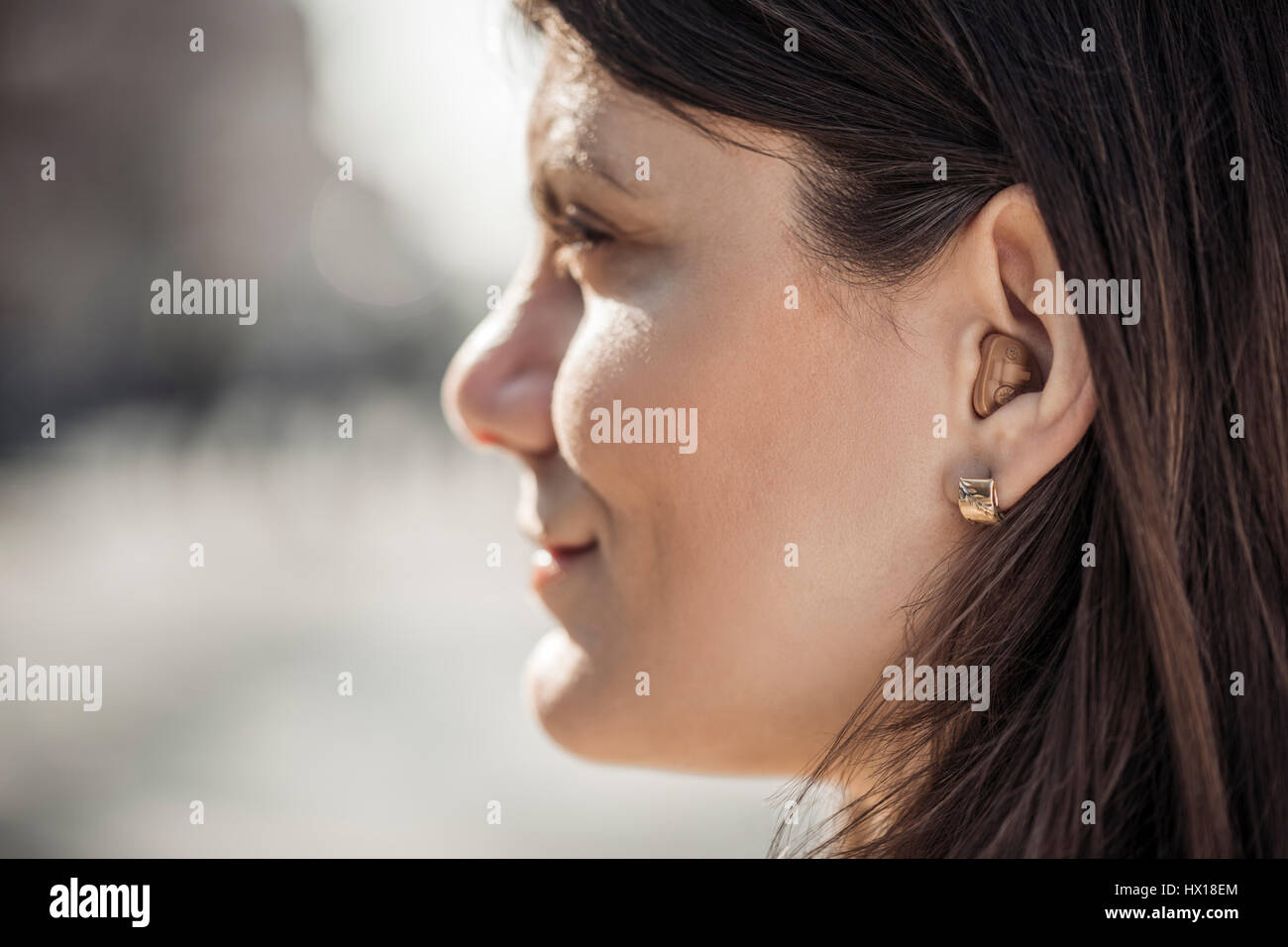Young woman with hearing aid, close-up Stock Photo