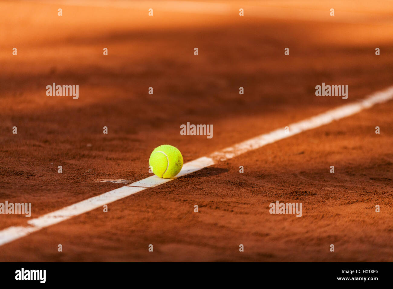 Tennis ball hitting the line on clay court Stock Photo Alamy