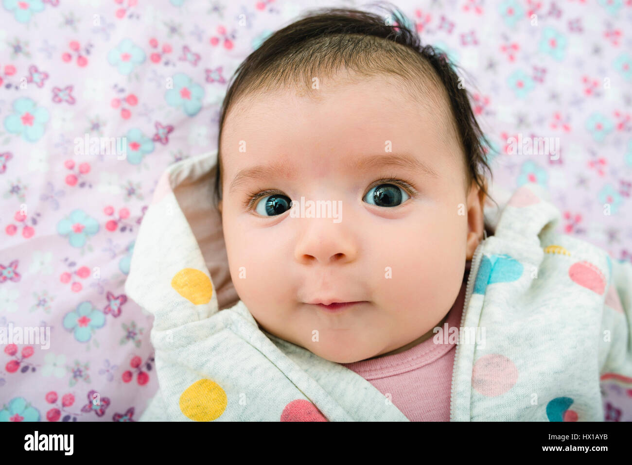 Portrait of baby girl lying on floral background Stock Photo - Alamy