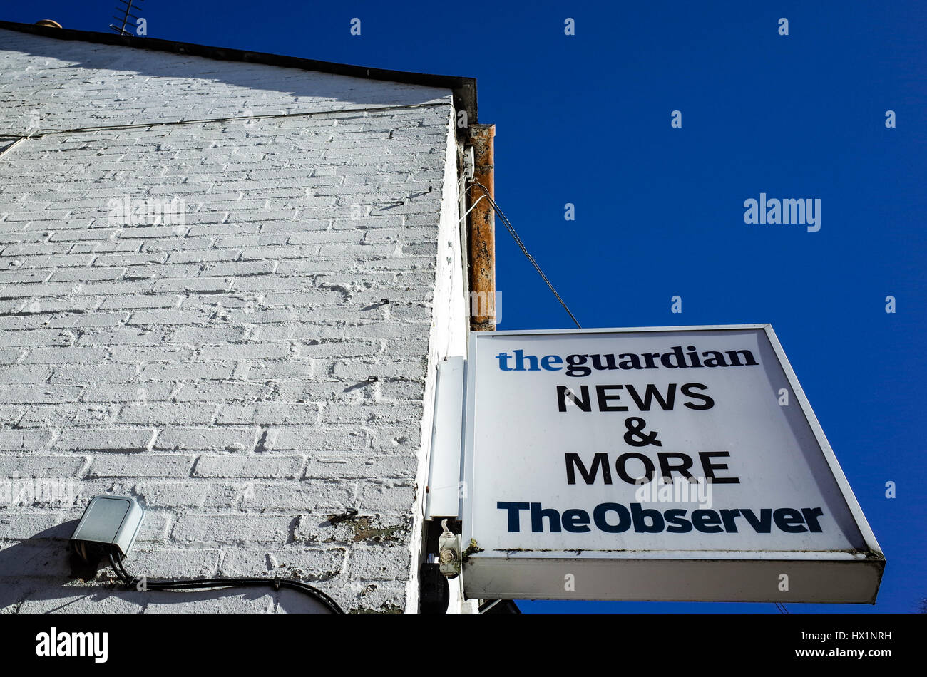 Sign for the Guardian and Observer newspapers outside a shop in Cambridge, UK. Stock Photo