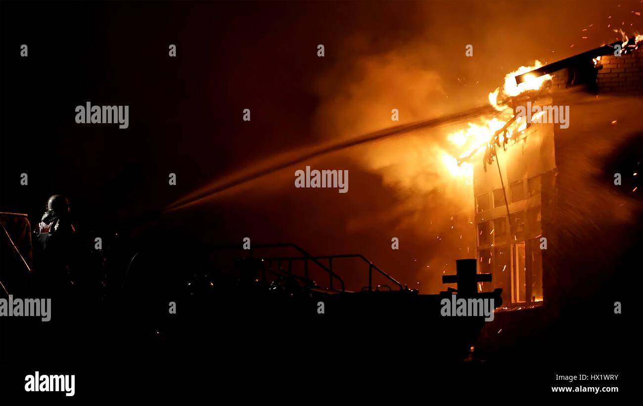 House on fire. Conflagration. Fireman fights fire Stock Photo Alamy