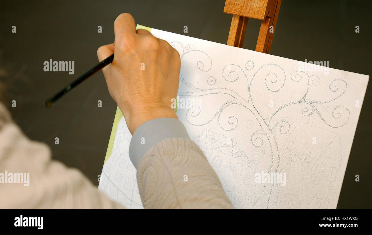 Female artist draws a pencil sketch in art studio Stock Photo