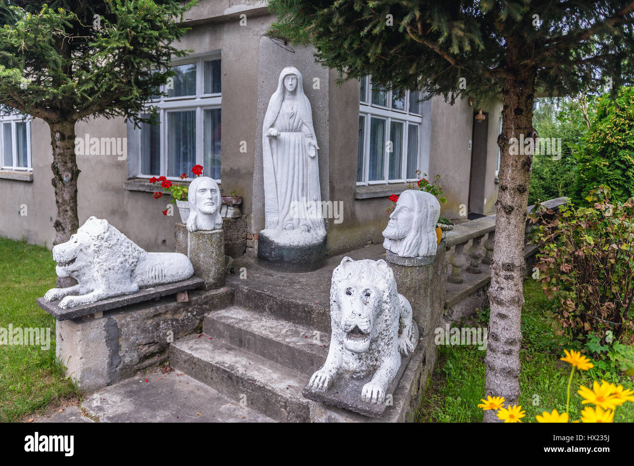 Stone sculptures in front of the house in Lesno village, Chojnice County on Kashubia region of Pomeranian Voivodeship in Poland Stock Photo