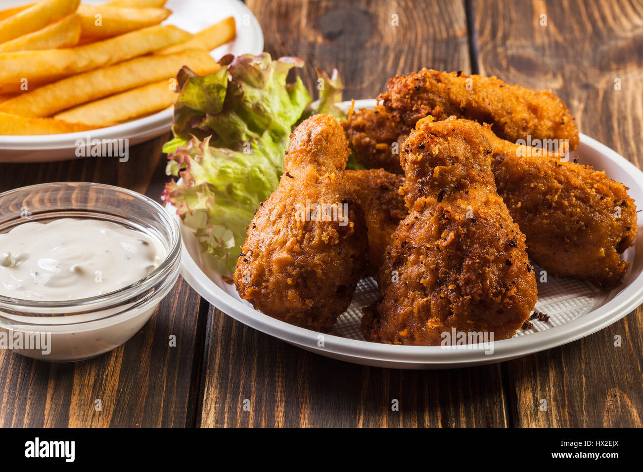 Crisp crunchy golden chicken wings with chips Stock Photo Alamy