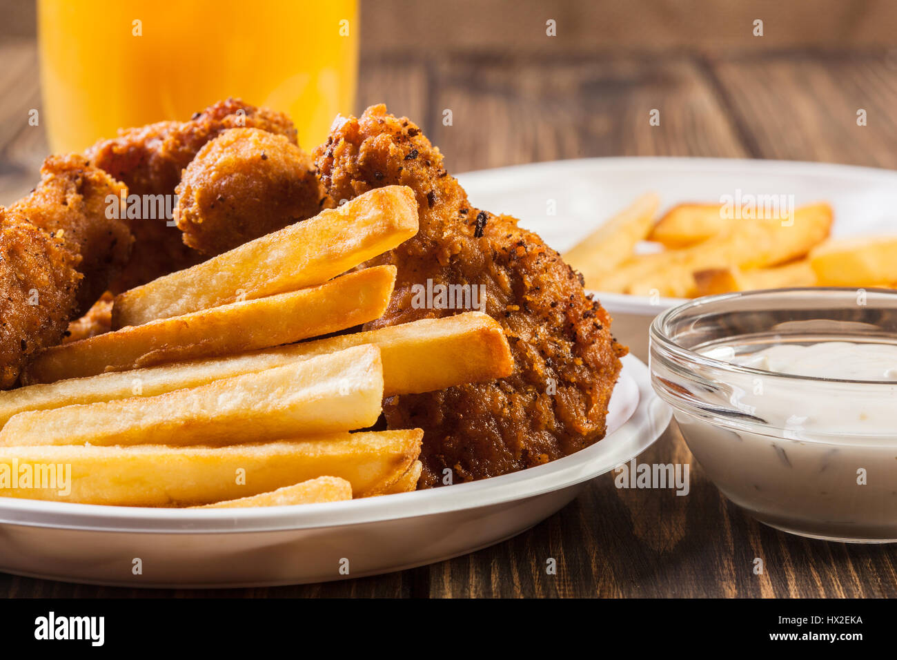 Crisp crunchy golden chicken wings with chips Stock Photo