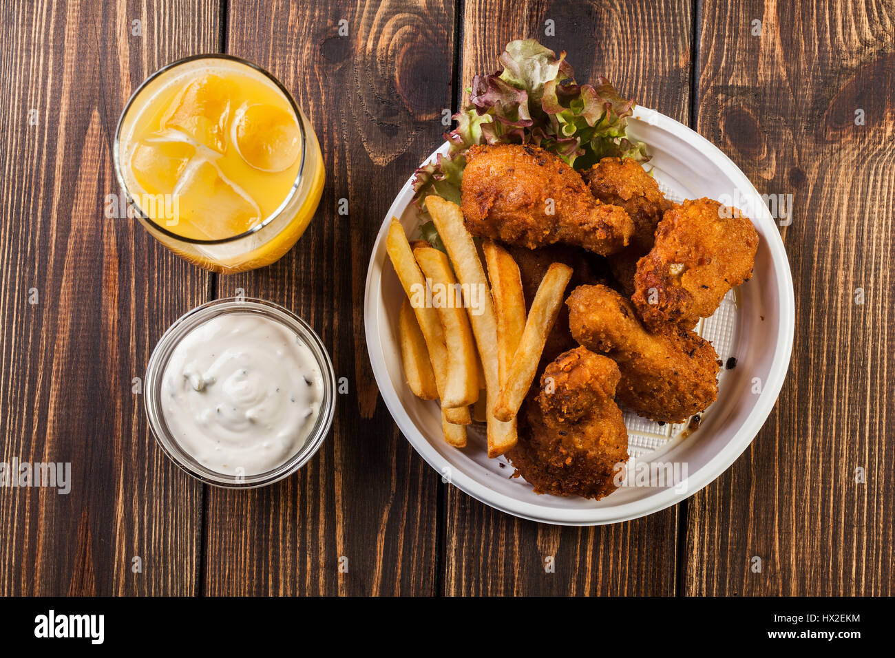 Crisp crunchy golden chicken wings with chips Stock Photo