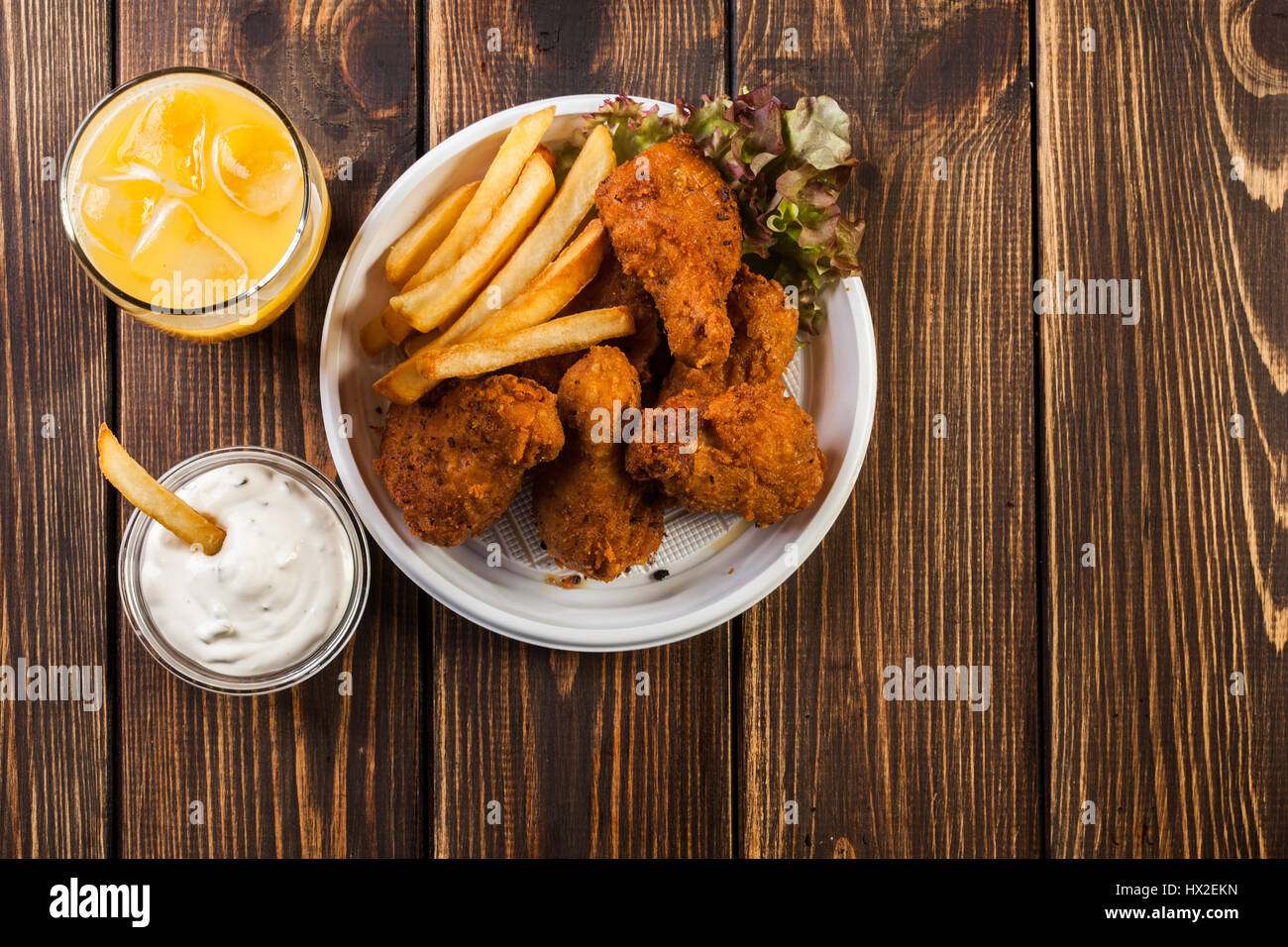 Crisp crunchy golden chicken wings with chips Stock Photo