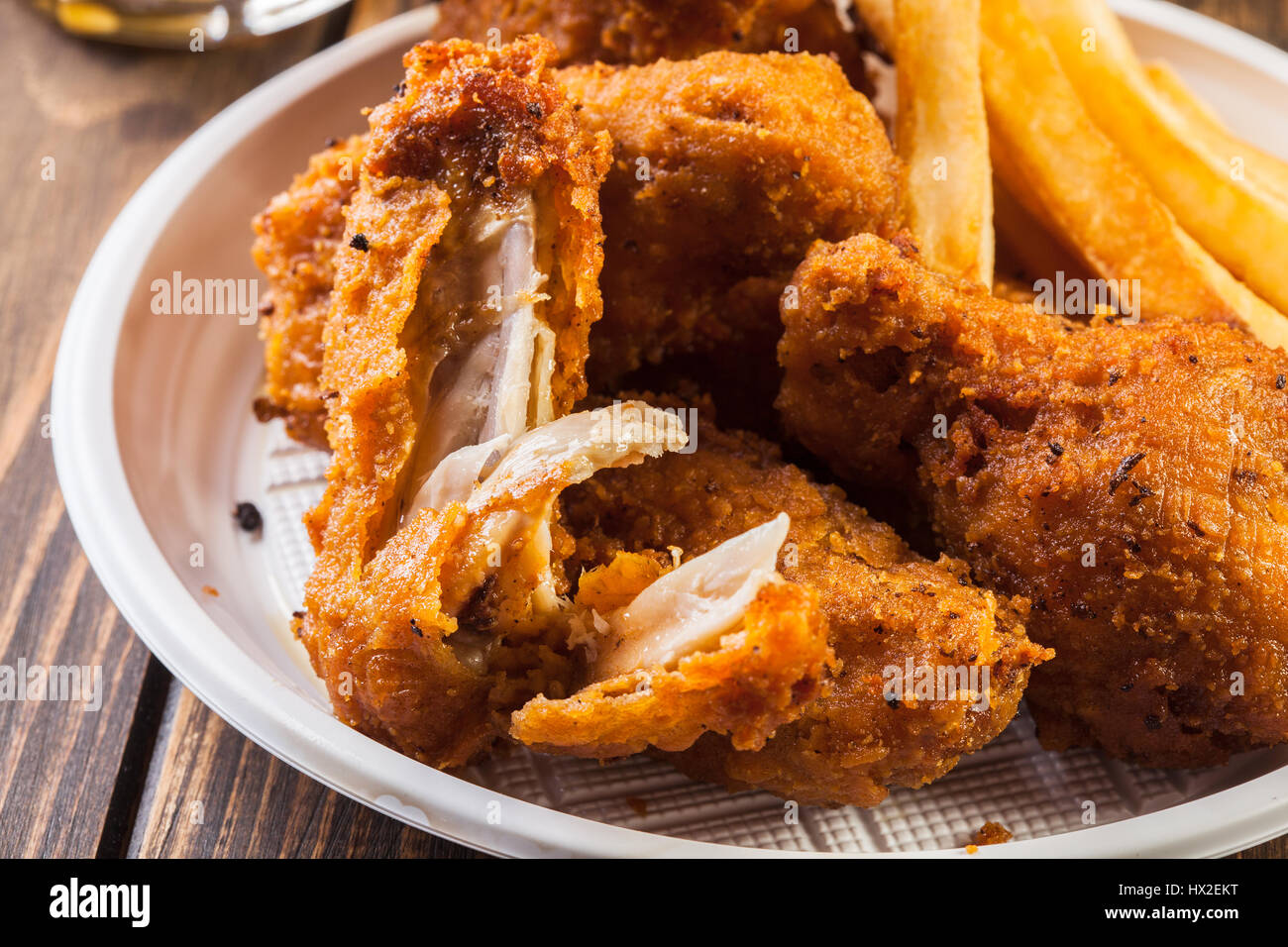 Crisp crunchy golden chicken wings with chips Stock Photo Alamy