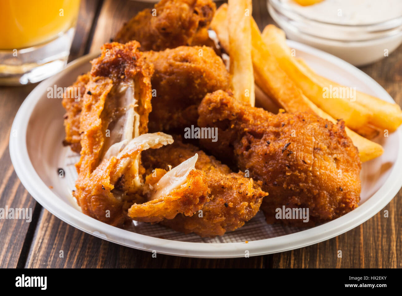 Crisp crunchy golden chicken wings with chips Stock Photo