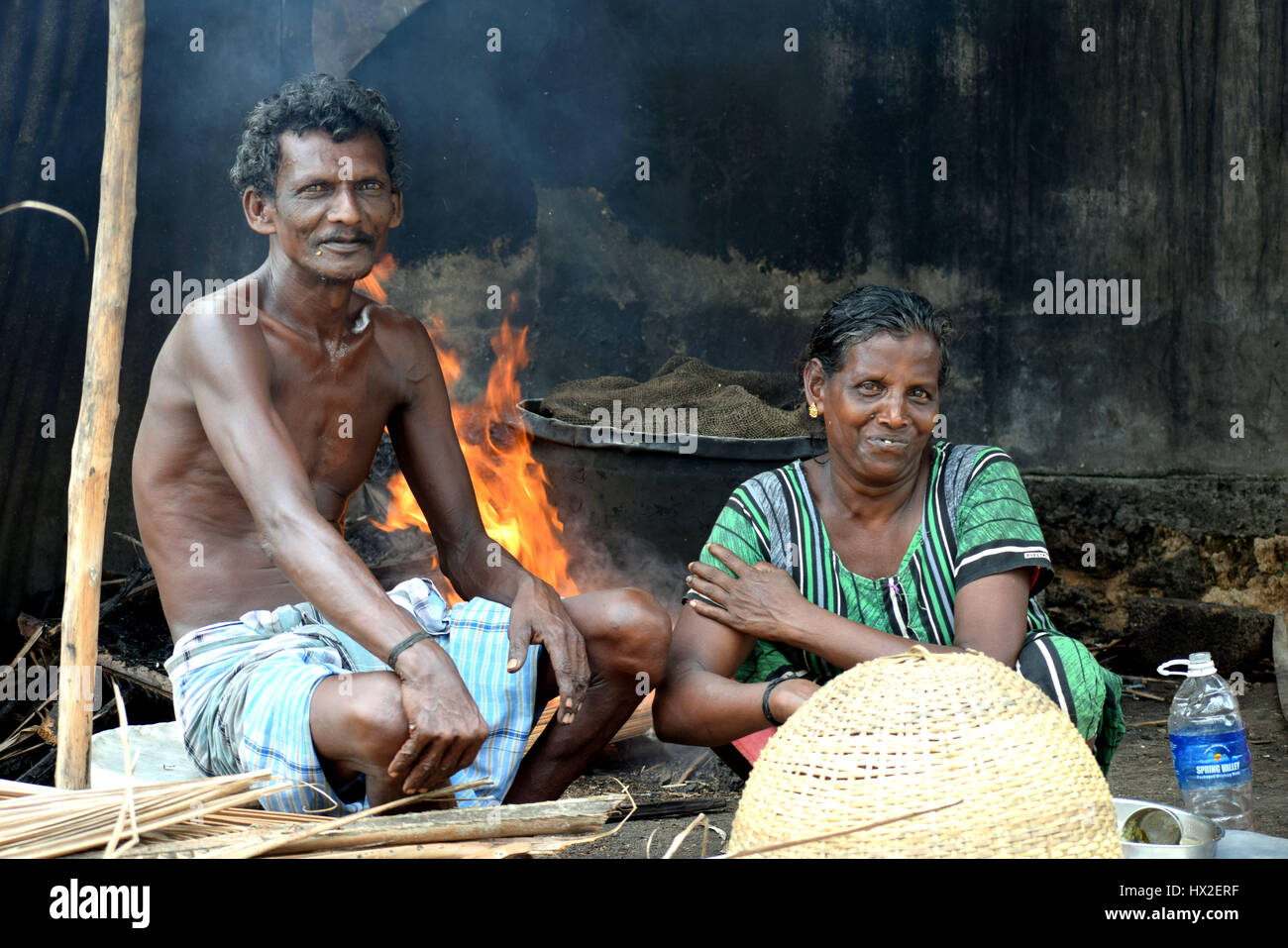 fisherman and his wife from Kerala (southern state of India) boiling the oysters they captured for selling Stock Photo