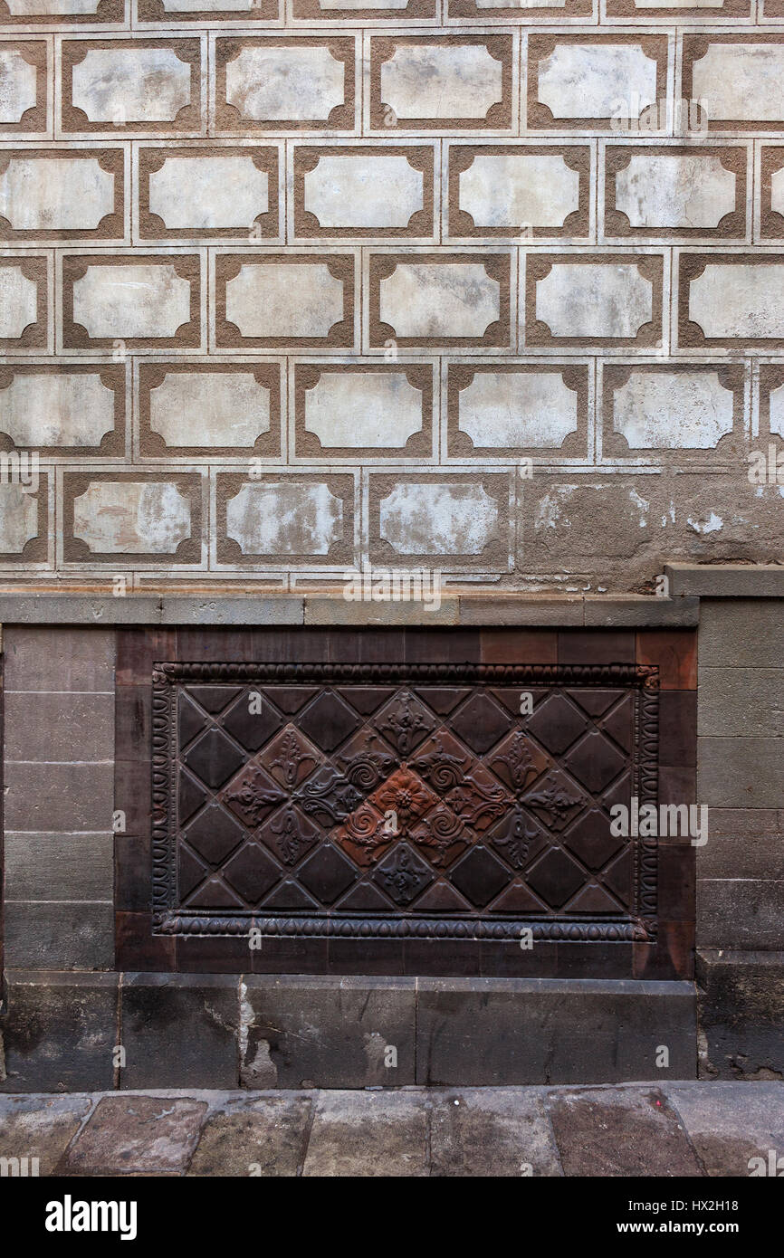 Historic building wall with geometric patterns and flowers and plants ...