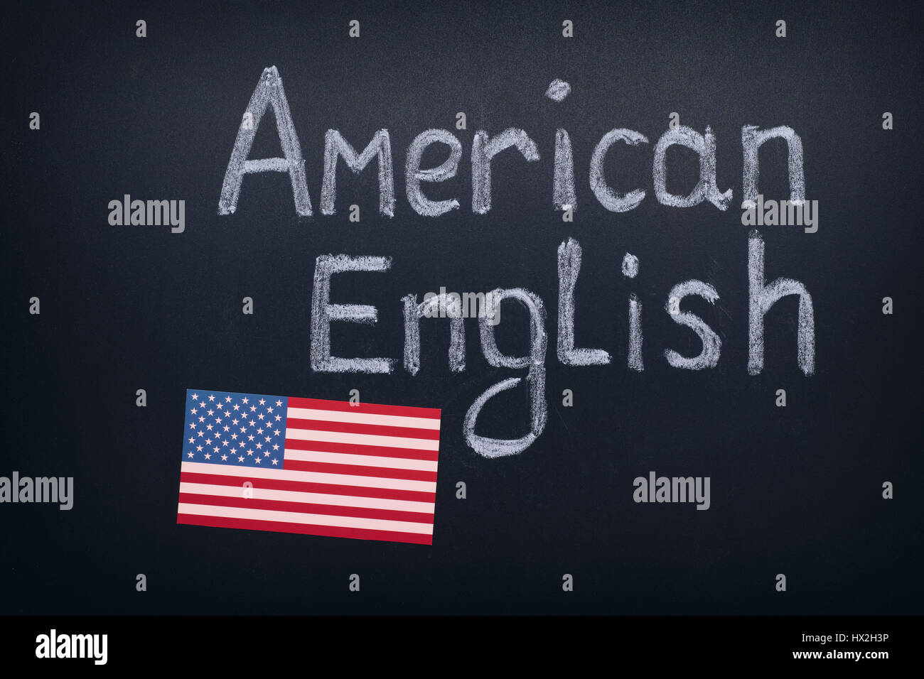 Hand drawing American English on blackboard. Close up. Stock Photo