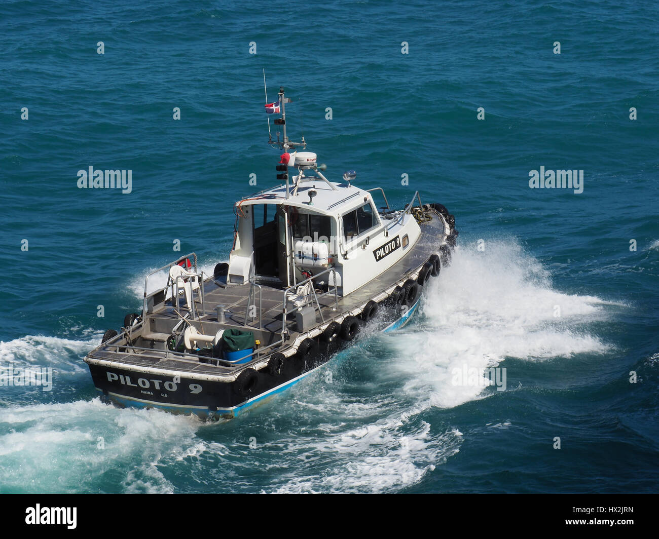 Pilot boat in rough seas at port of Amber Cove. Stock Photo