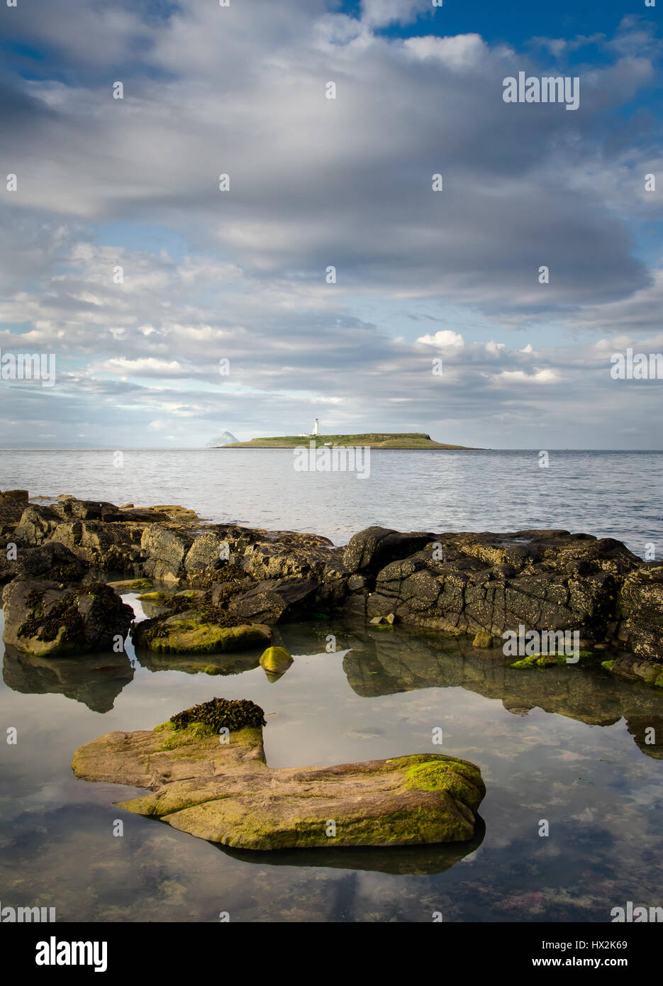 Pladda lighthouse with rocky coastline reflections, Isle of Arran, Scotland Stock Photo