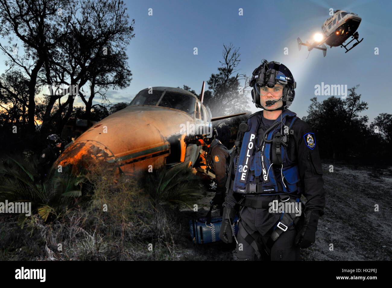 Western Australian Police Air Wing at work inspecting an abandoned aircraft, with their BK117 helicopter above. Stock Photo