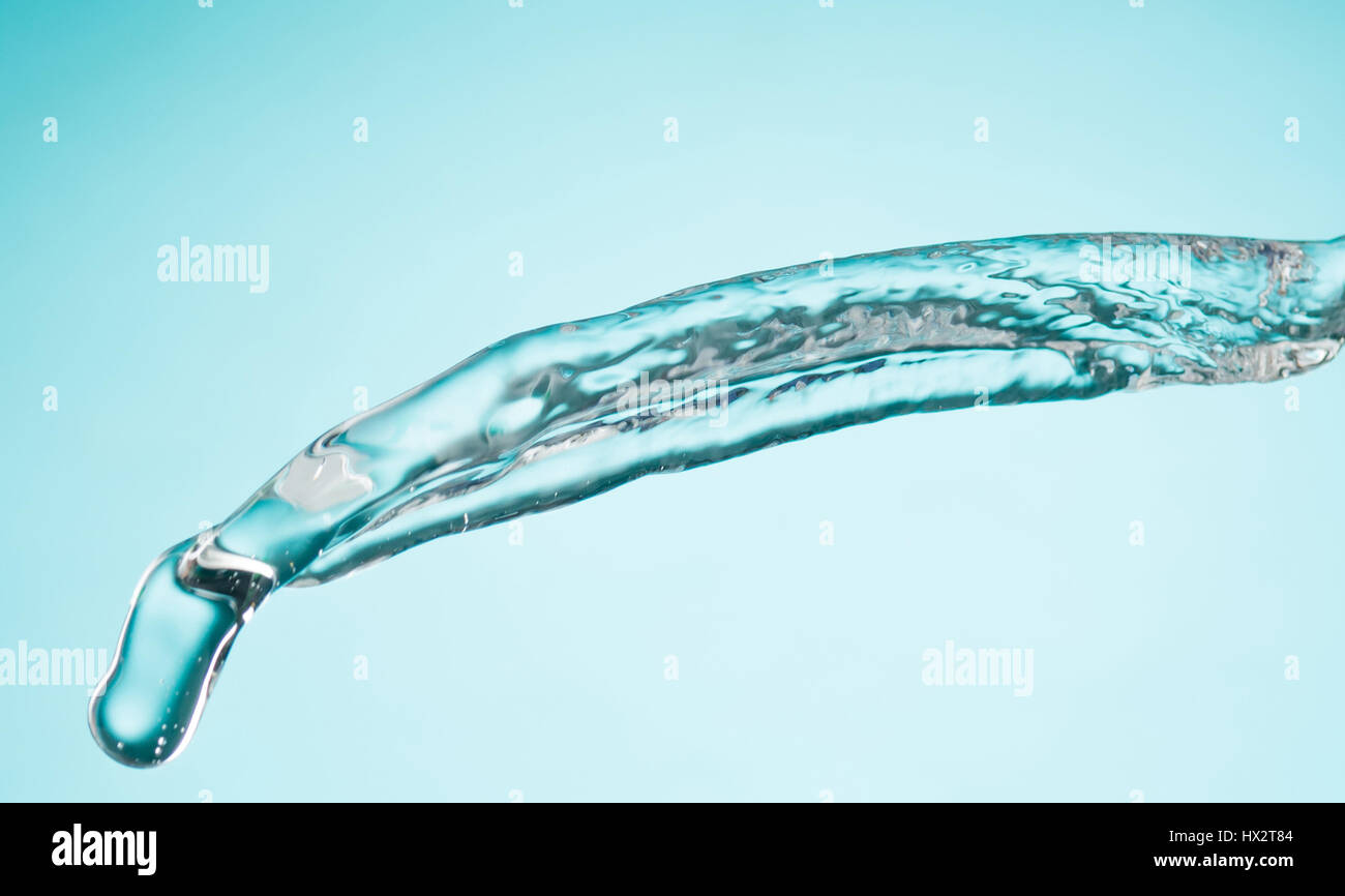 The water splash isolated on blue Stock Photo - Alamy