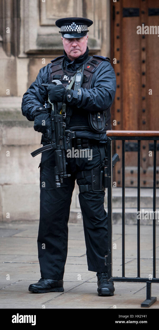 An armed police officer outside the Houses of Parliament in Westminster ...