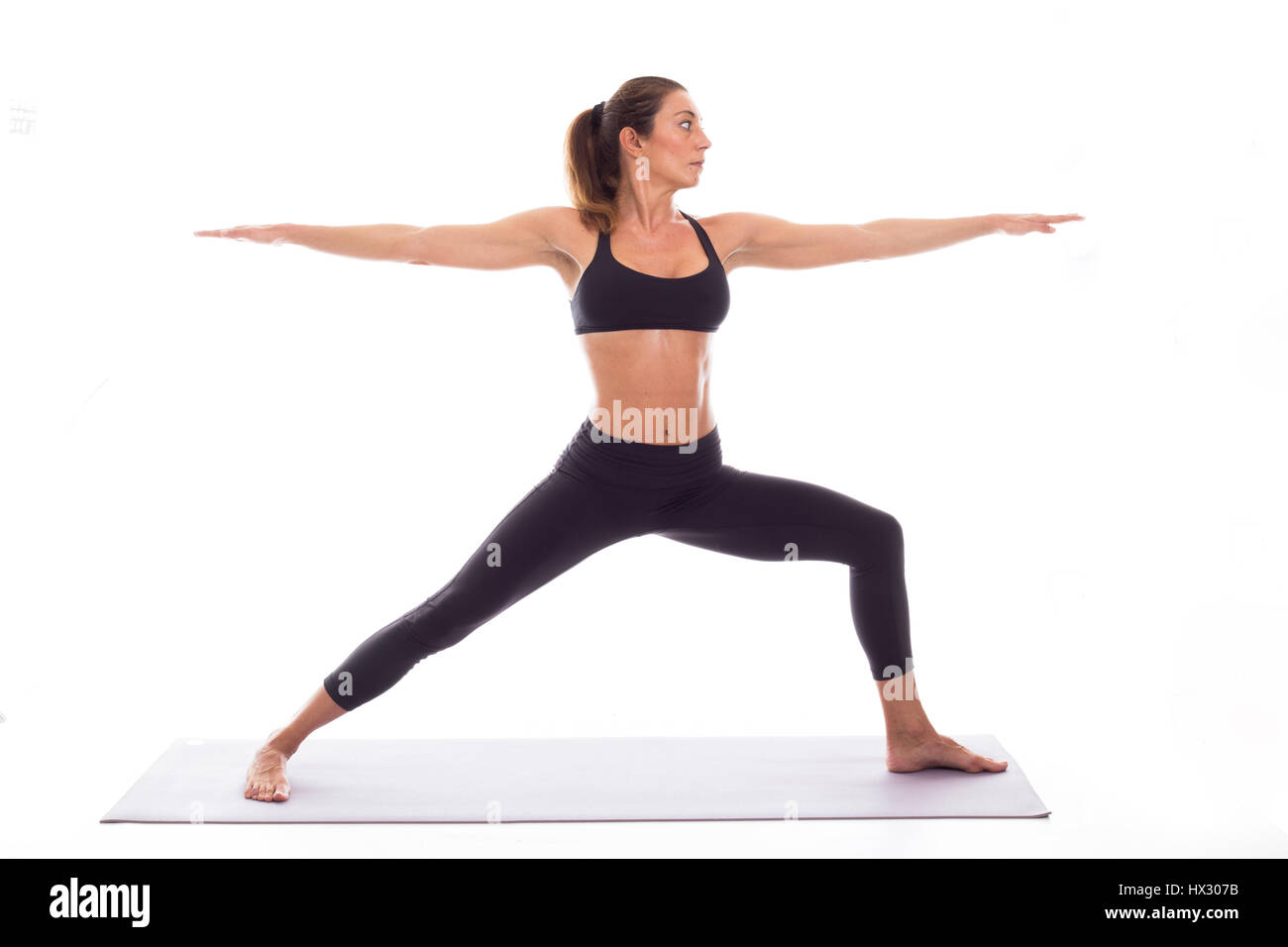 Studio shot of a young fit woman doing yoga exercises white background, Stock Photo