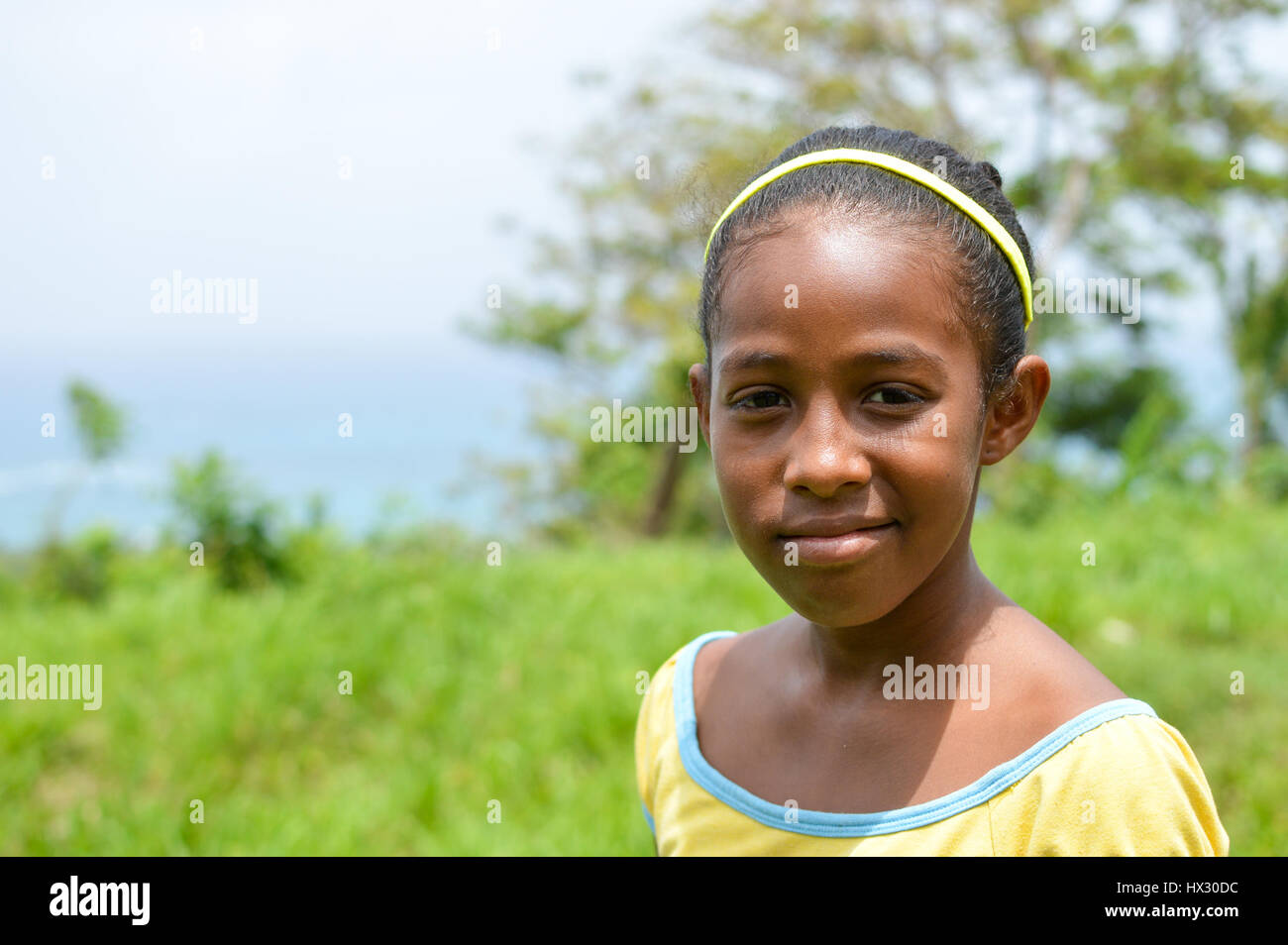 Great Corn Island, Nicaragua - July 6, 2015:  Beautiful Creole girl poses and smiles wearing funky colors on July 6, 2015 in Corn Island, Nicaragua Stock Photo