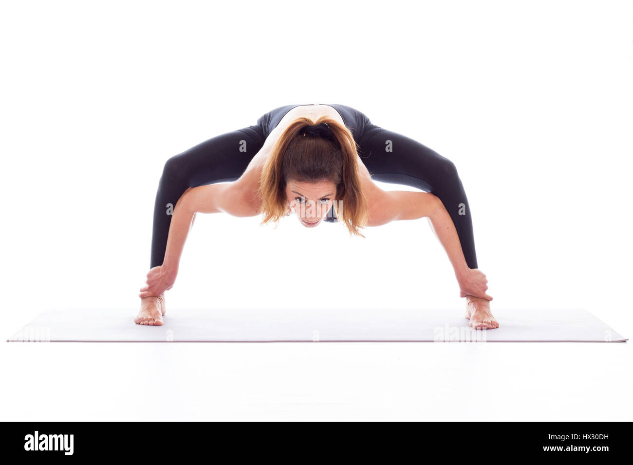 Studio shot of a young fit woman doing yoga exercises white background, Stock Photo