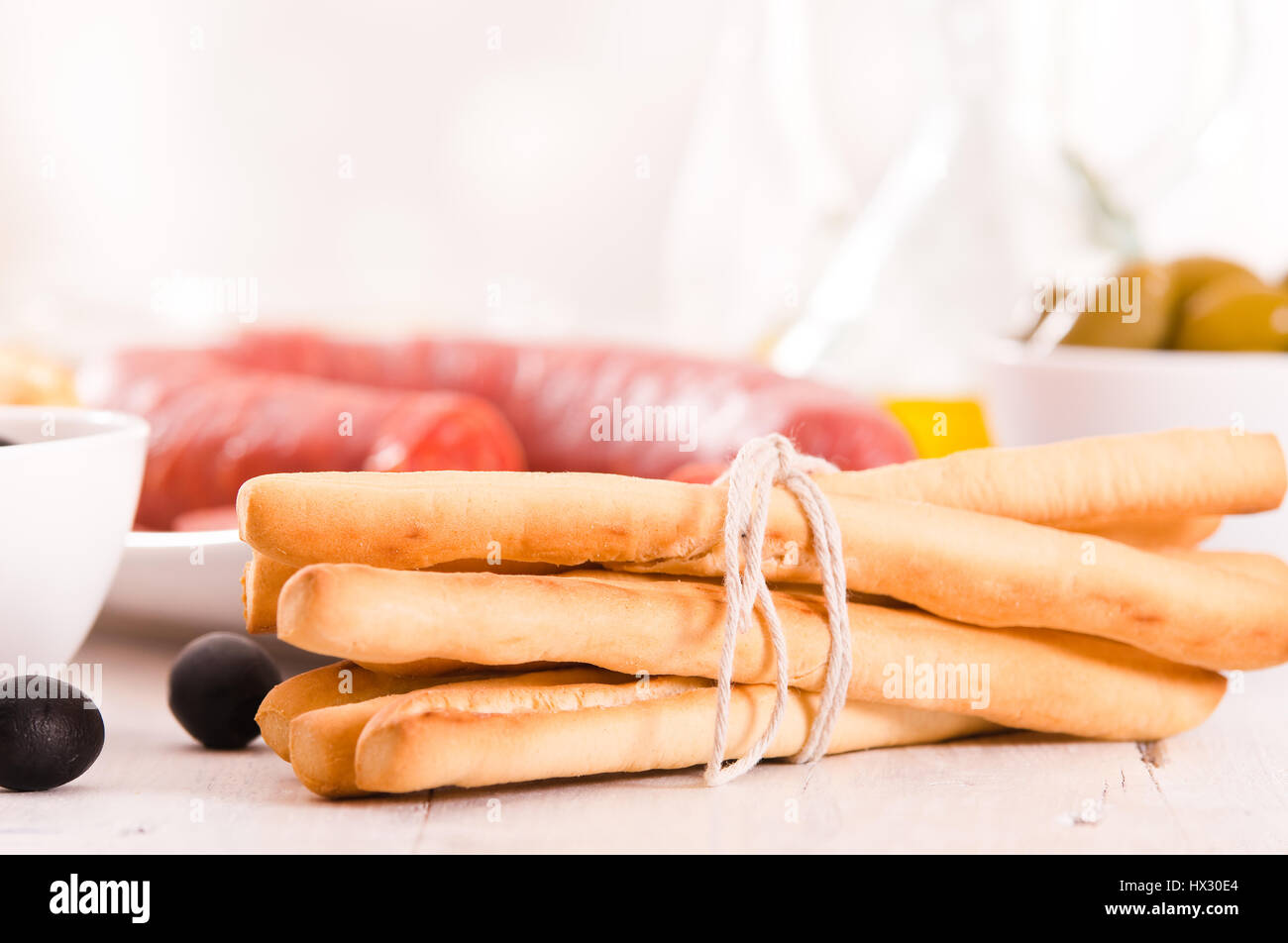 Grissini breadsticks with salami Stock Photo Alamy