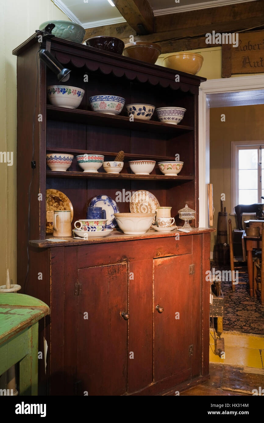 Brown antique wooden buffet with crockery and china in antique store located in 1810 old house interior Stock Photo