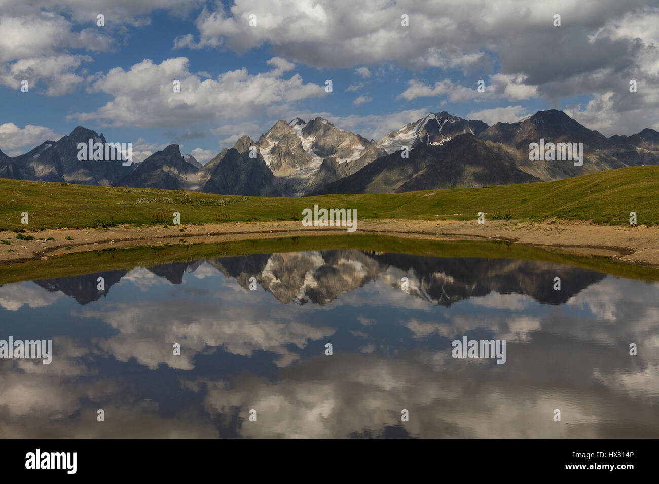 Reflections of the mountains in a lake, in the Caucasus Mountains, in Mestia, Georgia. Stock Photo