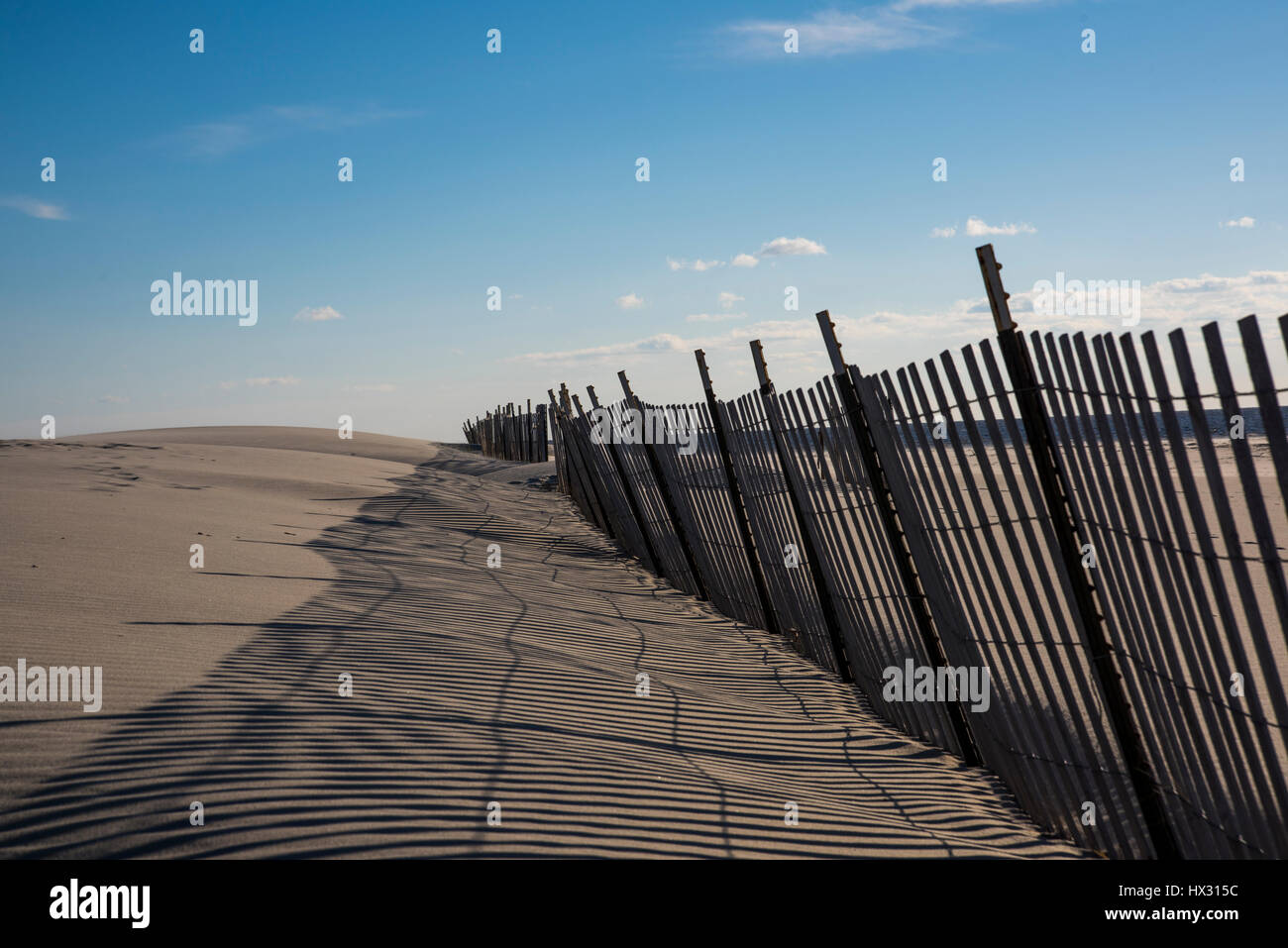 Sand ocean and snow fence Stock Photo