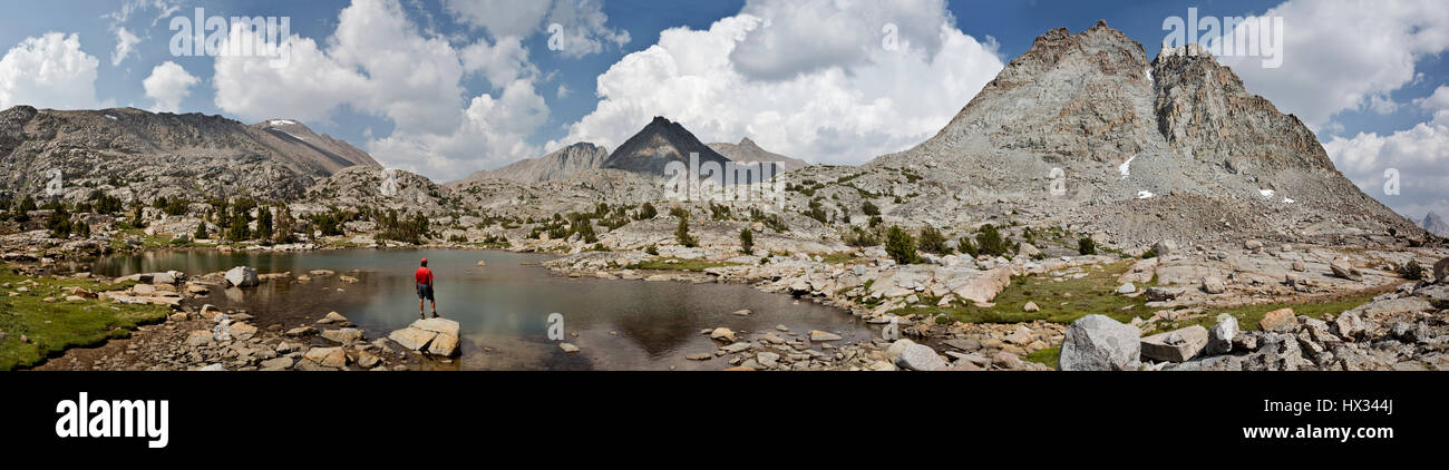 CA03101-00...CALIFORNIA - Hiker at a tarn on Darwin's Bench in the Kings Canyon Wilderness. Stock Photo