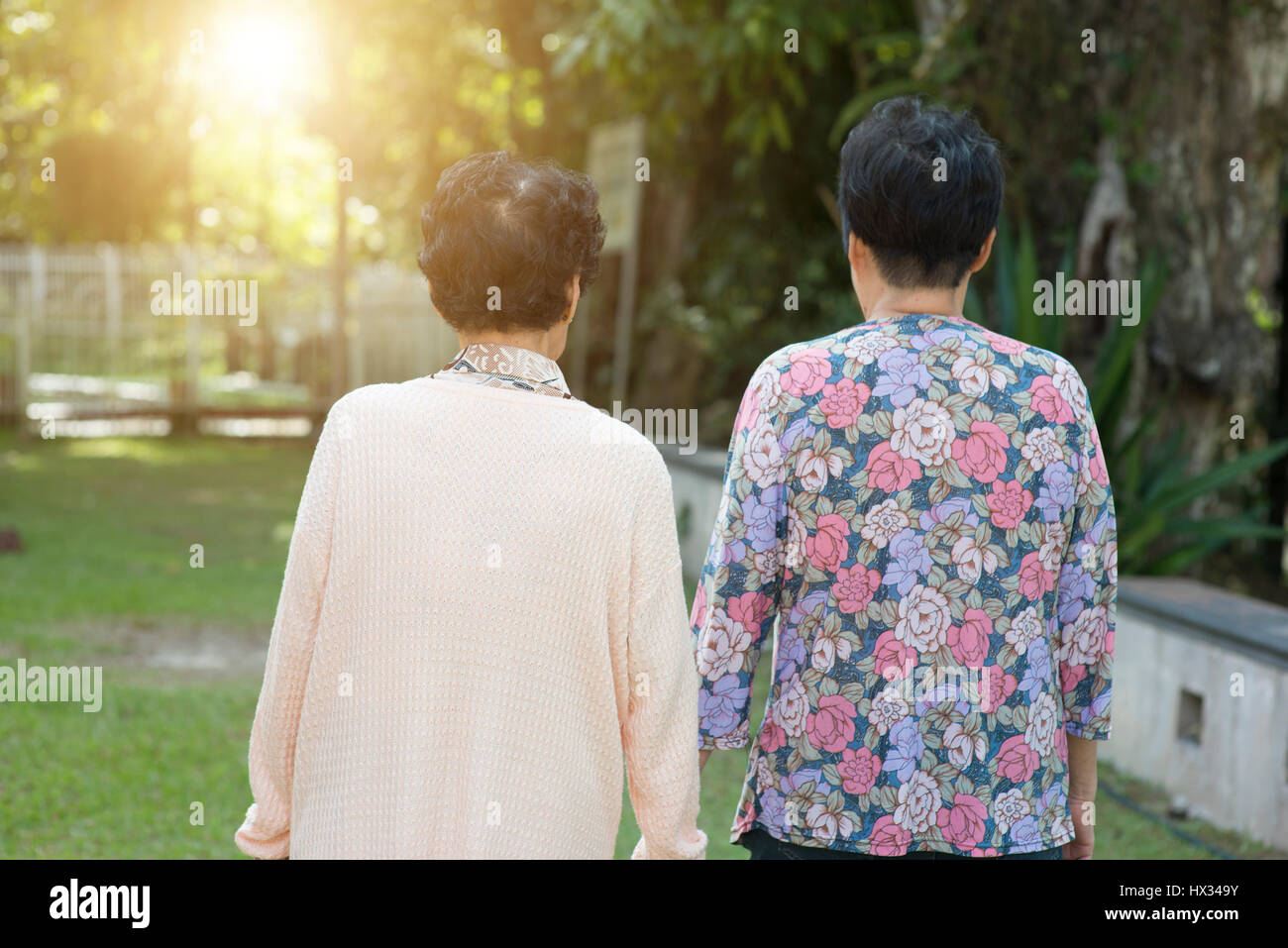 Candid shot of rear view Asian old women walking at outdoor park in the ...