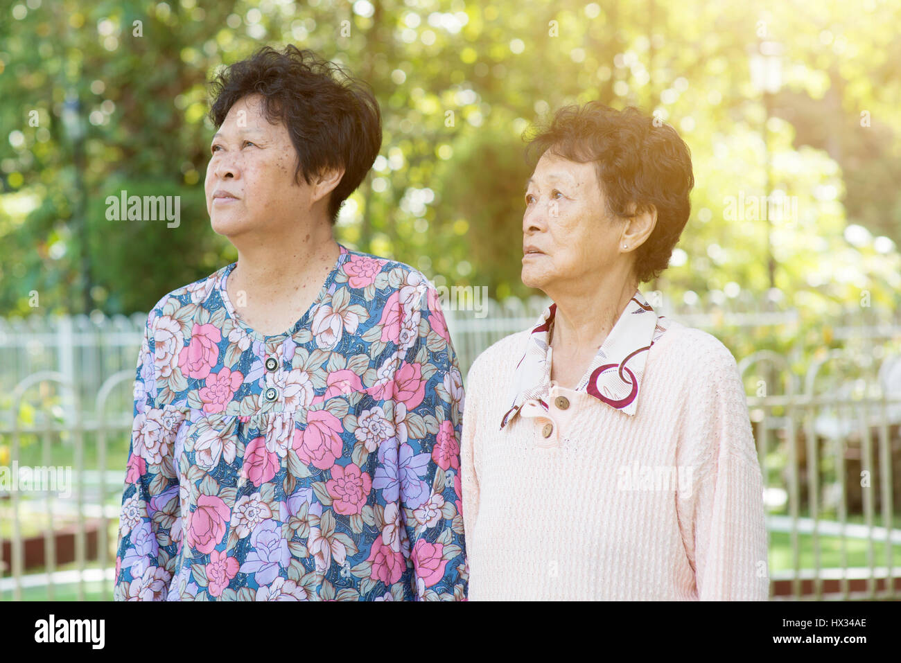 Candid shot of Asian elderly women walking at outdoor garden park in ...
