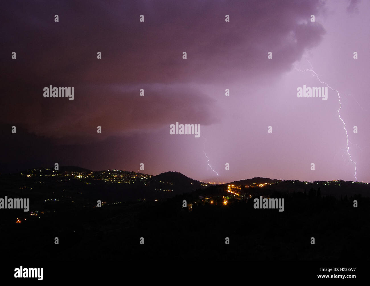 Night storm with bolts and thunders over the hills surrounding Florence Stock Photo