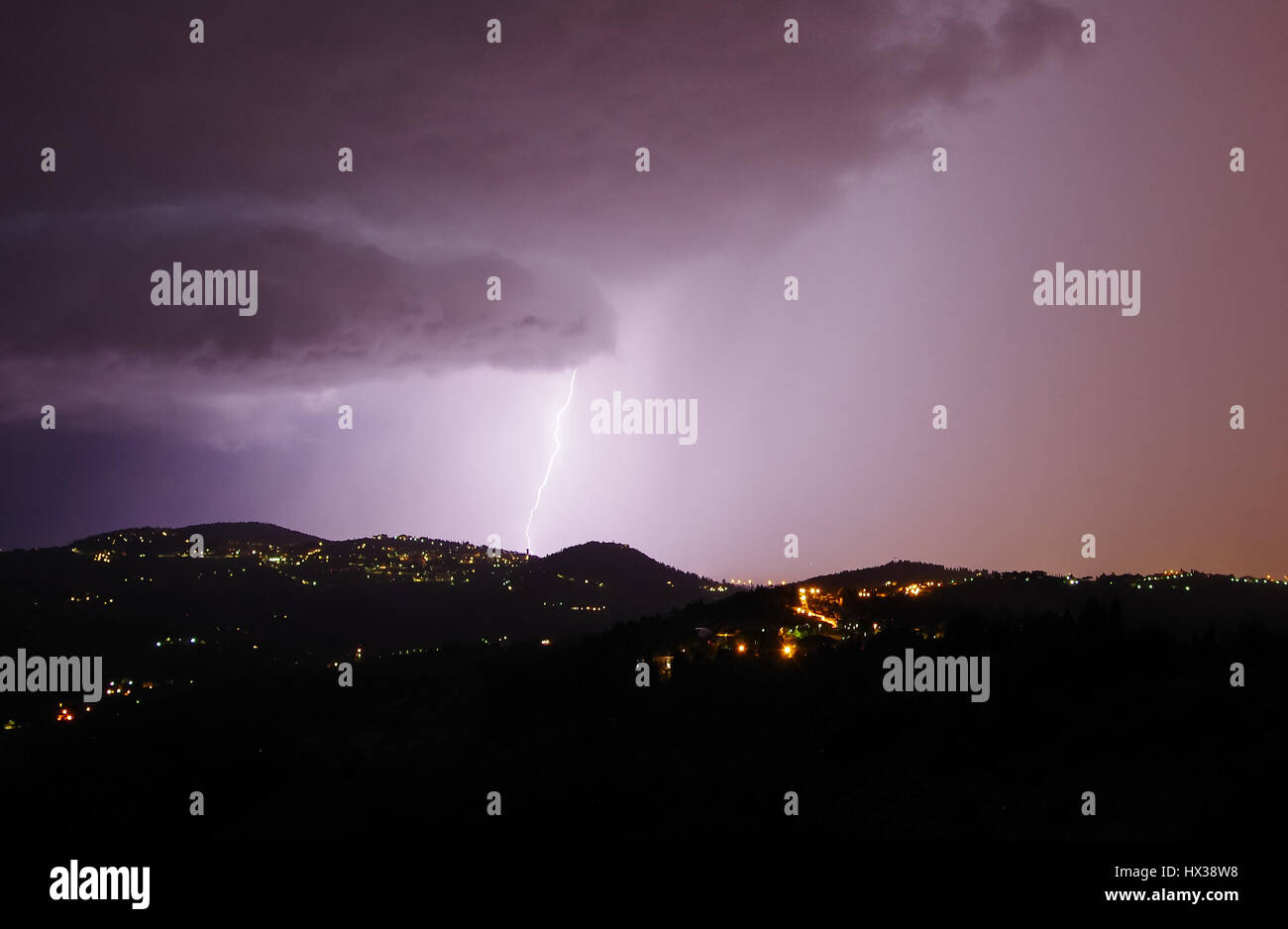 Night storm with bolts and thunders over the hills surrounding Florence Stock Photo