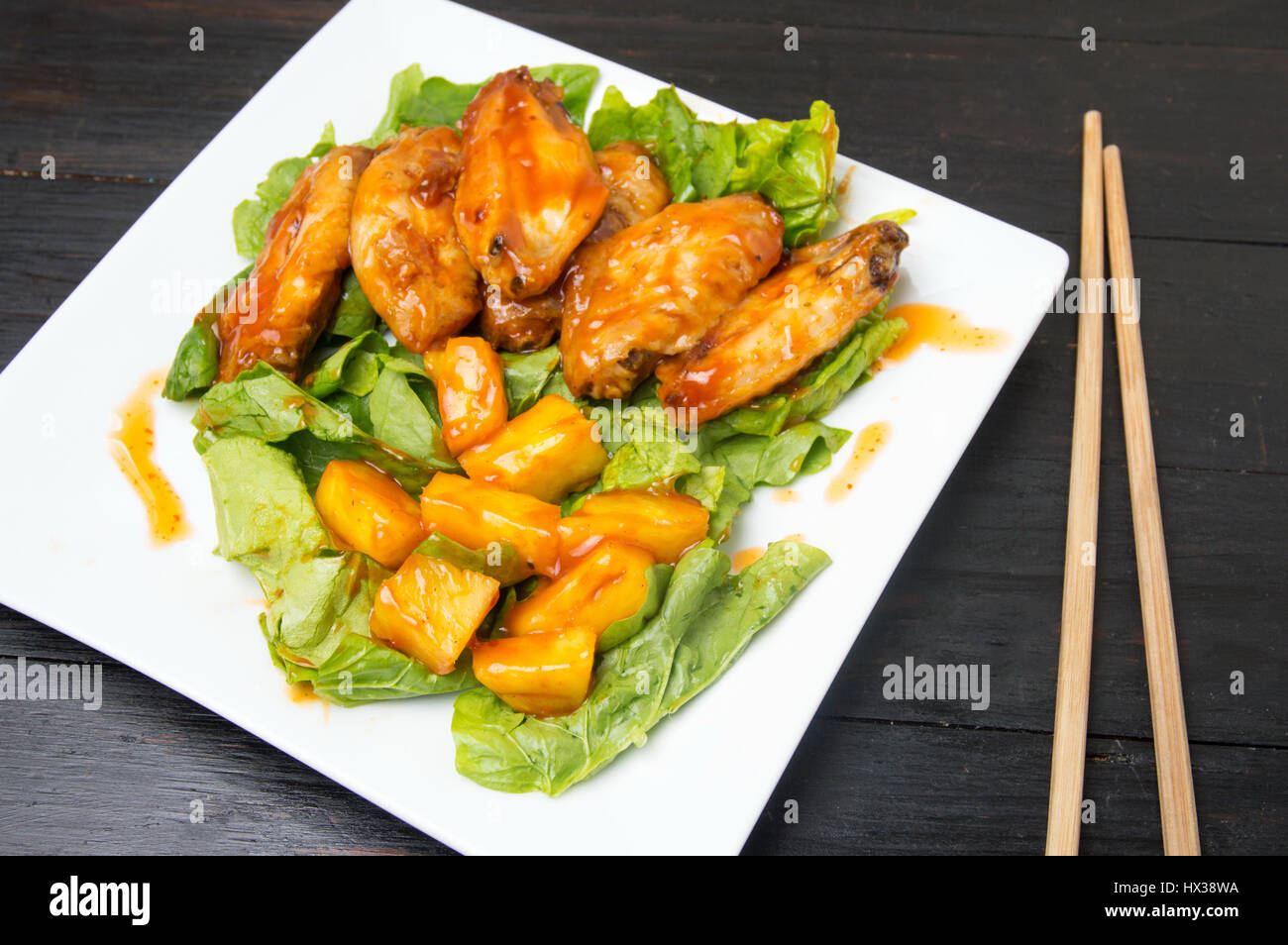 Pineapple chicken wings with barbecue and chili sauce served Stock
