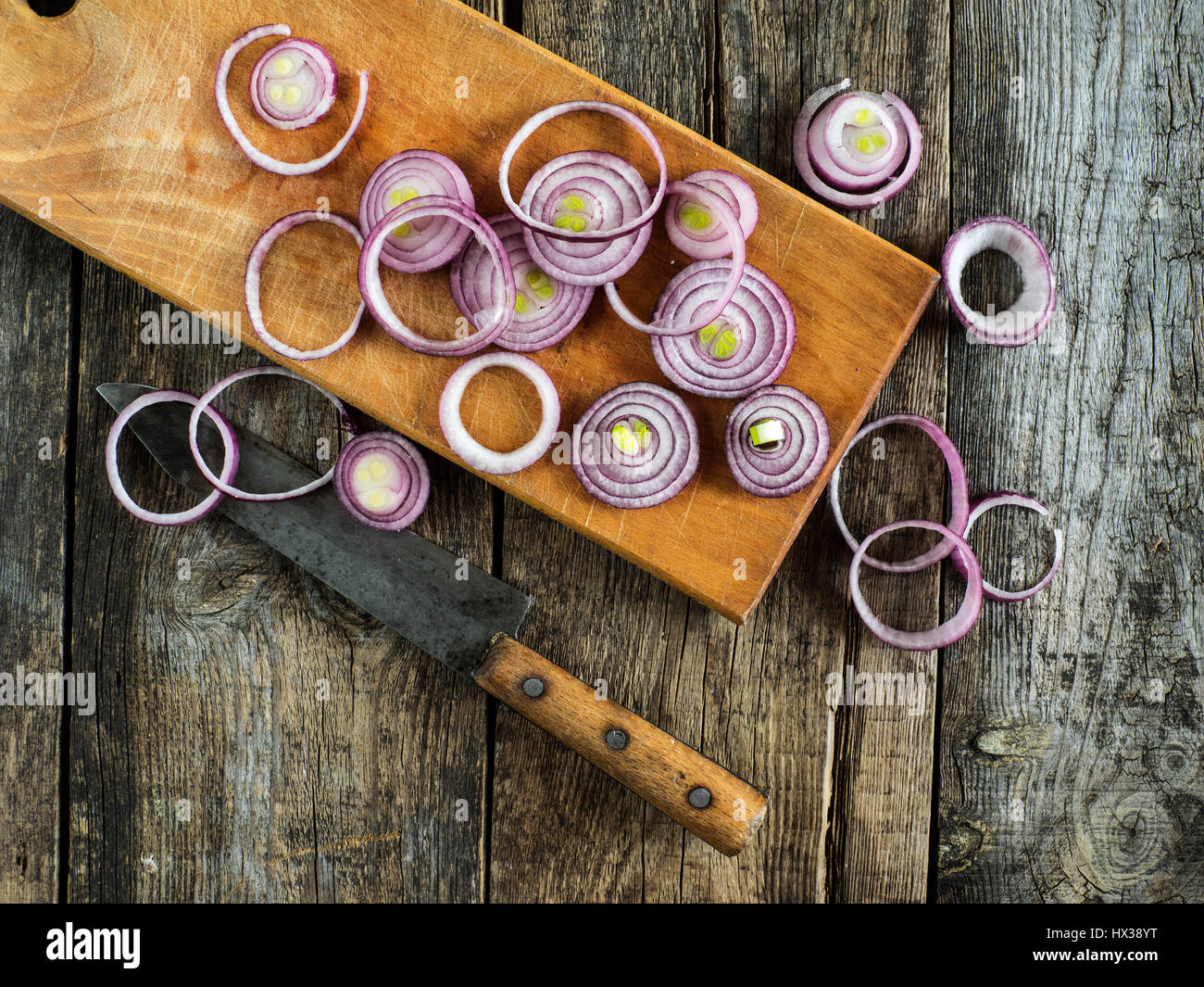 Sliced blue onion on an old weathered wooden table Stock Photo - Alamy