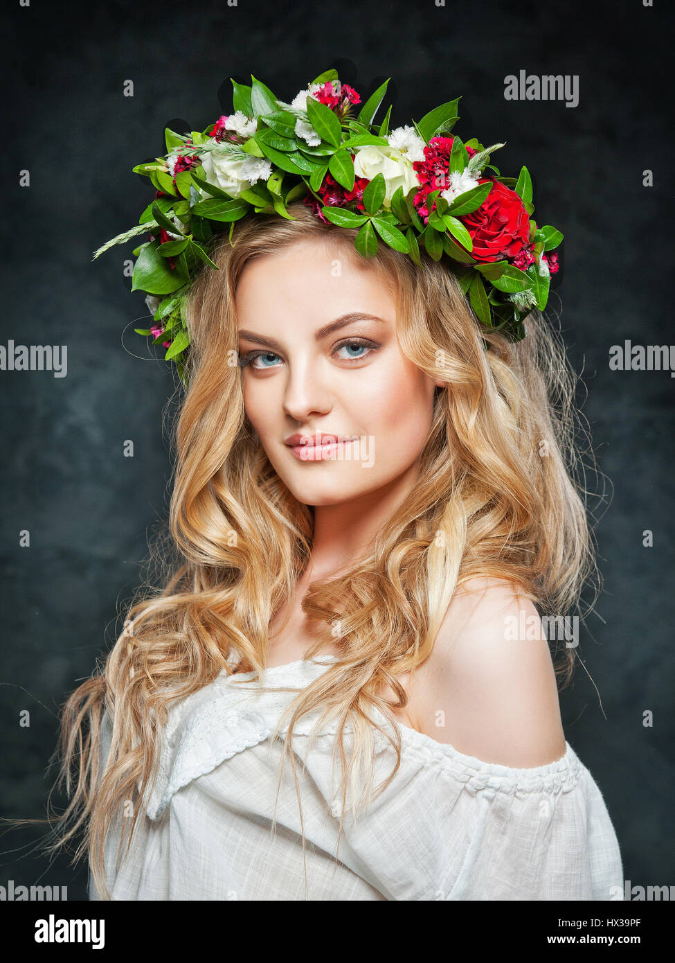 portrait of a beautiful blonde girl with a composition of flowers Stock ...