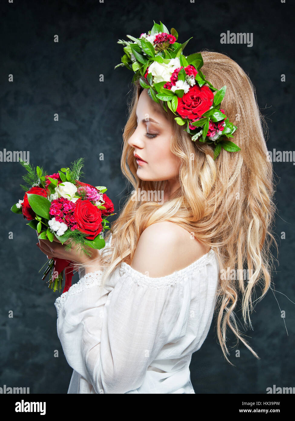 portrait of a beautiful blonde girl with a composition of flowers Stock ...