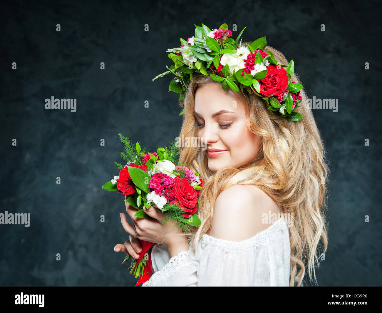 portrait of a beautiful blonde girl with a composition of flowers Stock ...