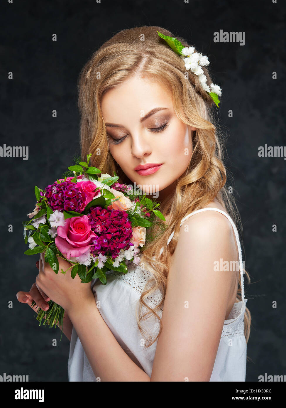 portrait of a beautiful blonde girl with a composition of flowers Stock ...