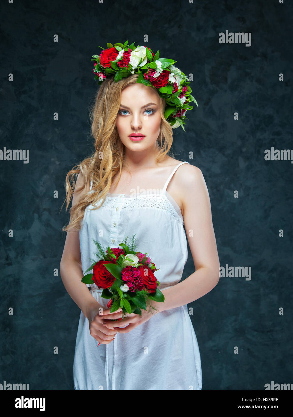 portrait of a beautiful blonde girl with a composition of flowers Stock ...