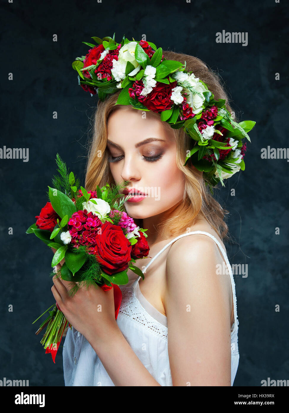 portrait of a beautiful blonde girl with a composition of flowers Stock ...