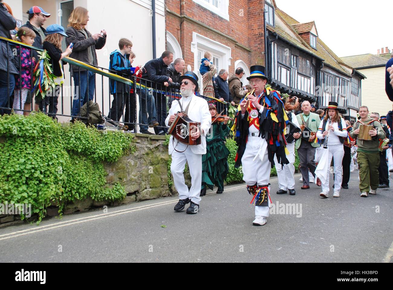 Morris dancers parade through the Old Town during the annual Jack In The Green festival at Hastings in East Sussex, England on May 7, 2012. Stock Photo