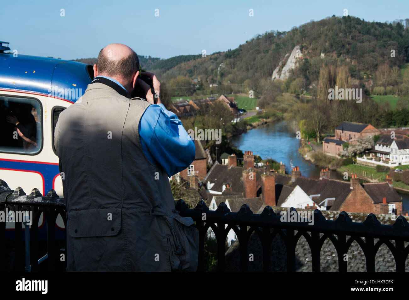 Man taking a photograph of a pleasant English scene. (It's the River Severn in the background.) Stock Photo