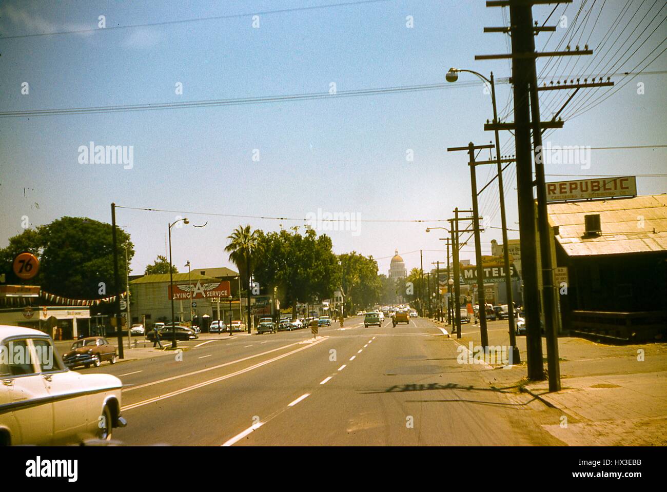 The California State Capitol building can be seen in the distance when looking down this this busy street in Sacramento, California, 1955. Stock Photo