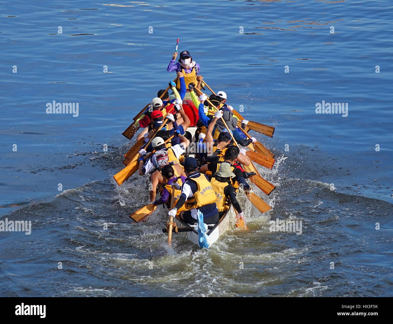 KAOHSIUNG, TAIWAN -- JUNE 18, 2015: An unidentified team competes in the 2015 Dragon Boat Races on the Love River in Kaohsiung City. Stock Photo