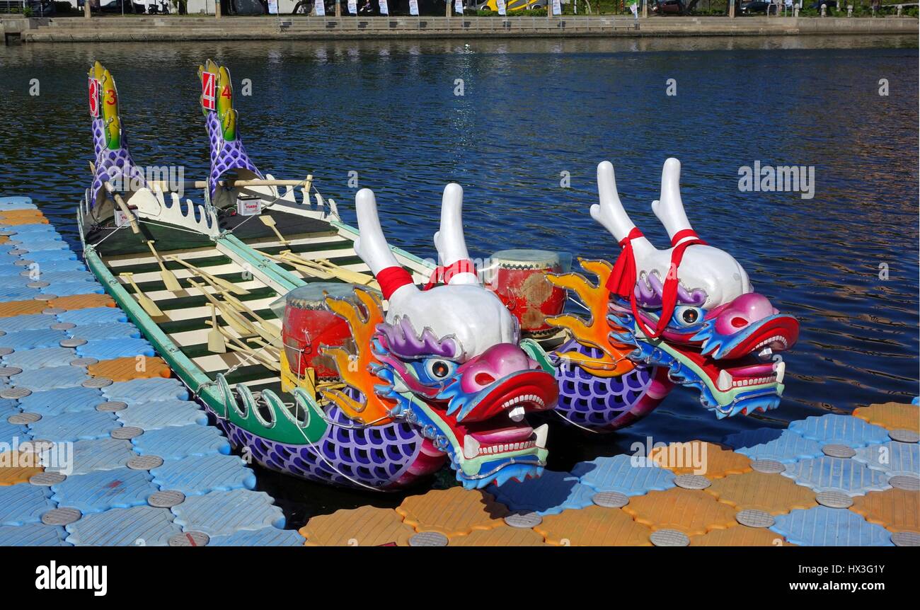 KAOHSIUNG, TAIWAN -- JUNE 14, 2015: Boats with the traditional dragon head sculpture design are prepared for the yearly Dragon Boat Races on the Love  Stock Photo