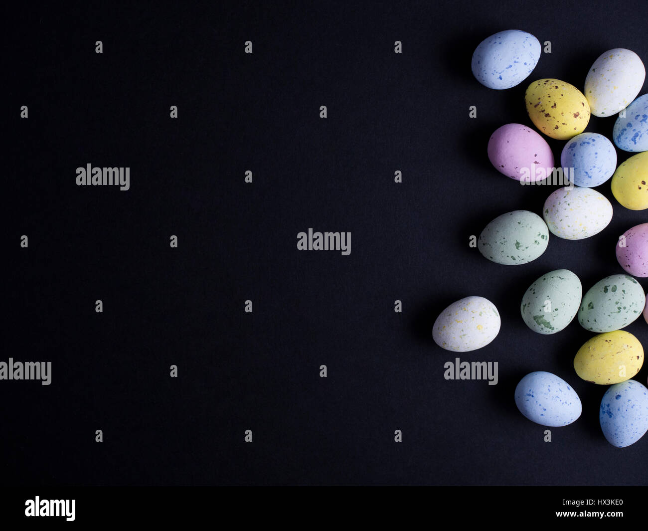 Chocolate easter eggs in pastel colors isolated on black background ...