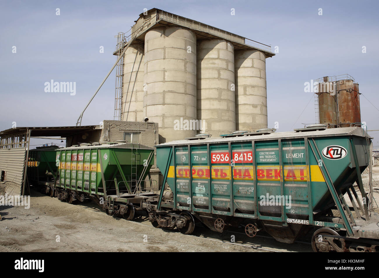 St. Petersburg, Russia - April 27, 2009: Railway wagons for transportation of dry cargo, freight train with car load of cement, wagon collecting cemen Stock Photo