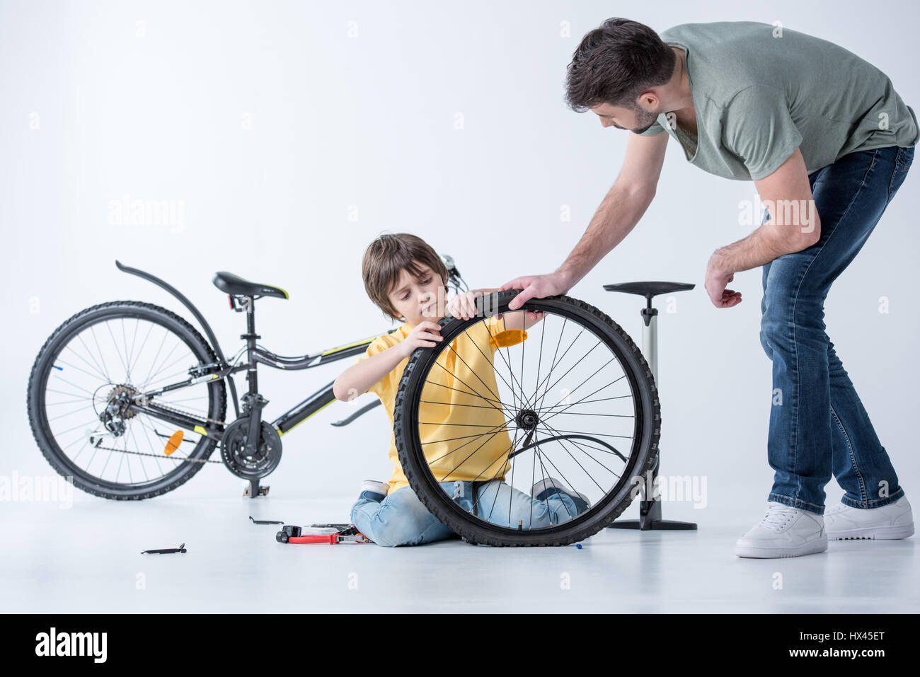 Son repairing bike hi-res stock photography and images - Alamy